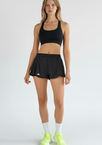 Layer Womens AeroFlow pleated running shorts black full body view worn for running and training