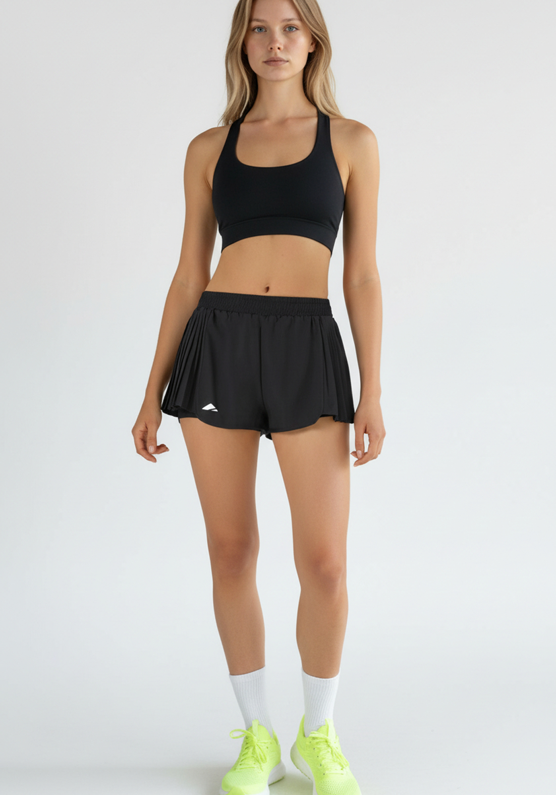Layer Womens AeroFlow pleated running shorts black full body view worn for running and training