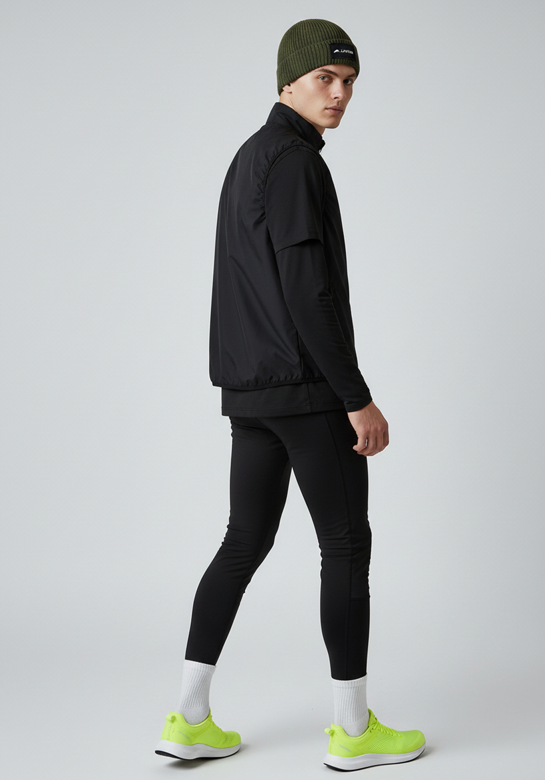 Rear view of Layer ColdLYR running beanie khaki worn with winter running kit