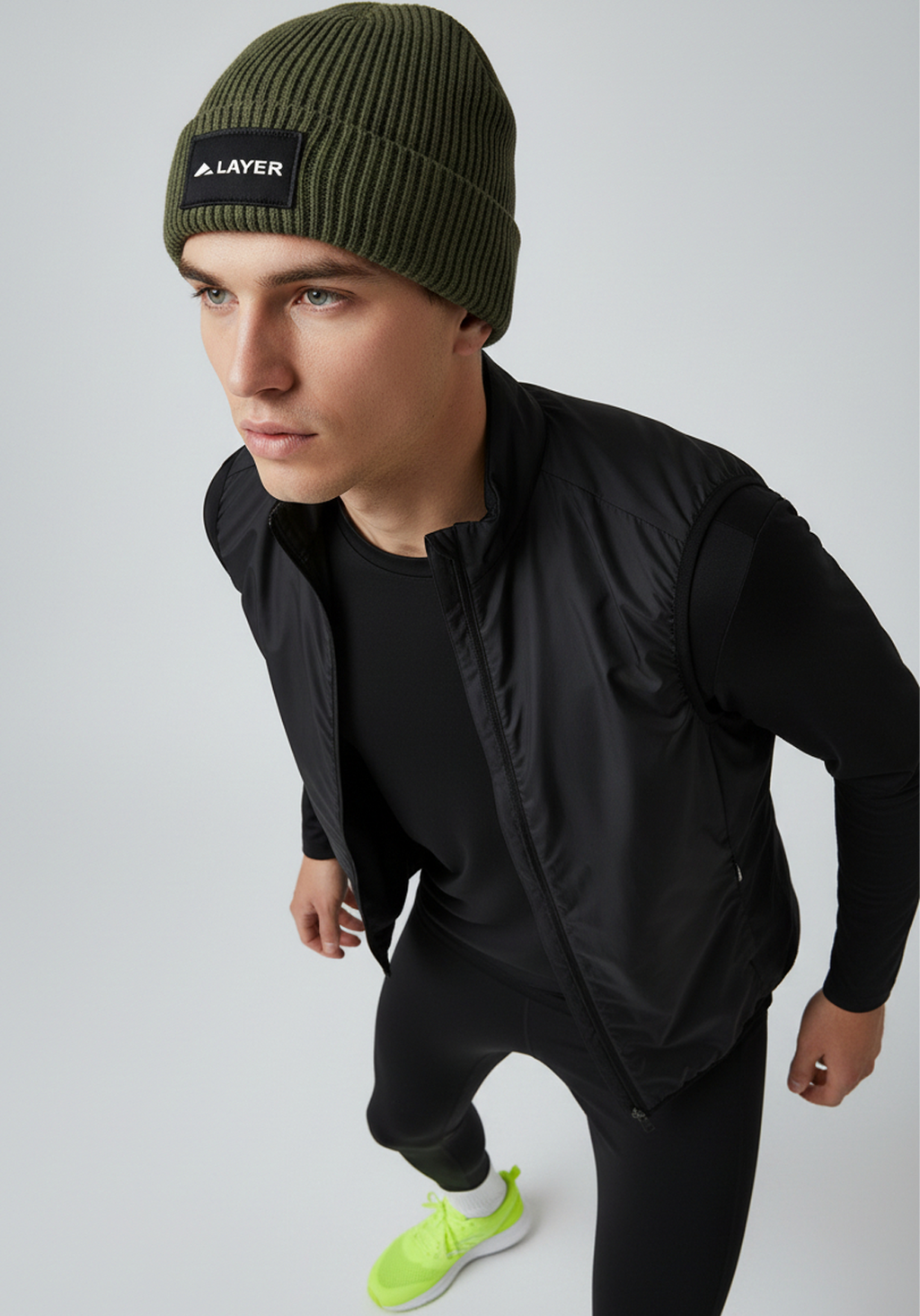 Close up of Layer ColdLYR running beanie khaki showing ribbed knit and Layer patch