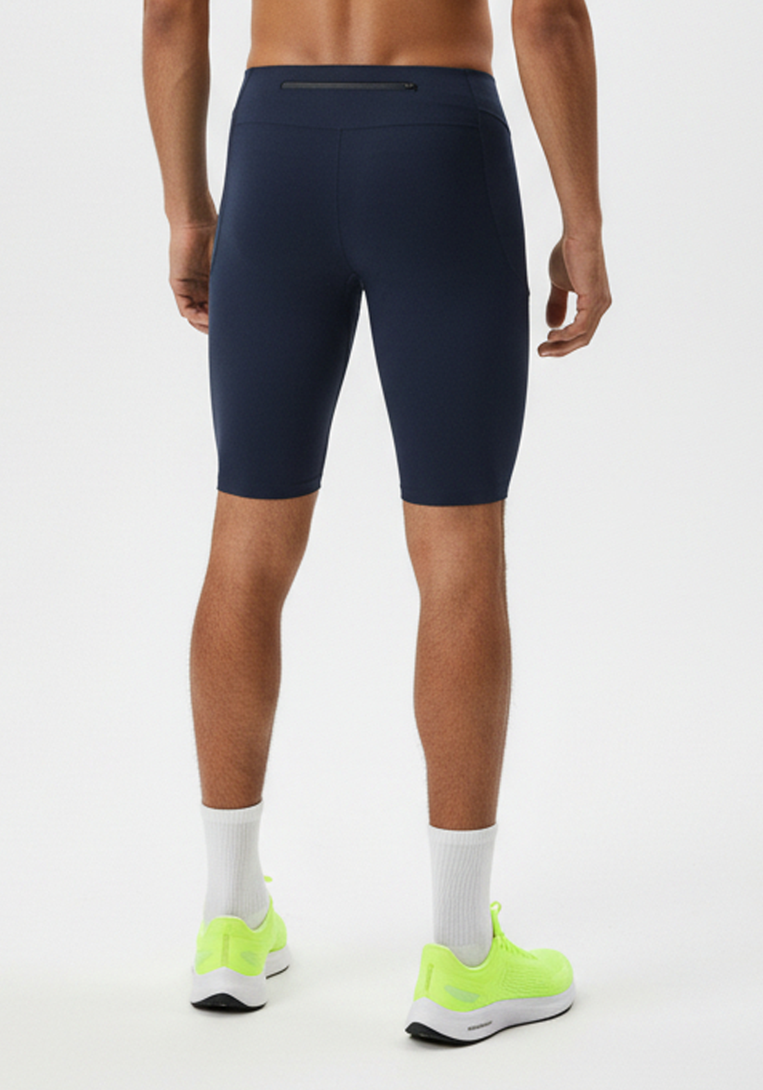 Close up rear view of Layer Core Run short tights in navy highlighting zip pocket placement