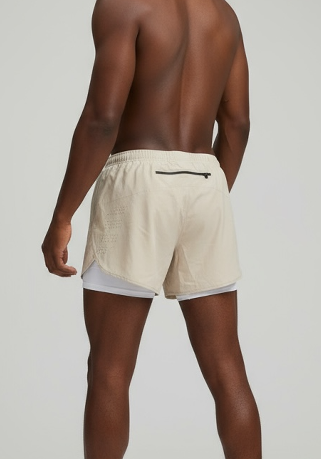 Layer Men’s Engage 2-in-1 Running Shorts in beige – model wearing performance shorts made for training and everyday runs