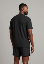 Back view of Layer FTR Shadow Tee in black showing clean silhouette and lightweight performance fabric