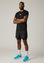 Full body front view of athlete wearing Layer FTR Shadow Tee black styled with training shorts For The Run