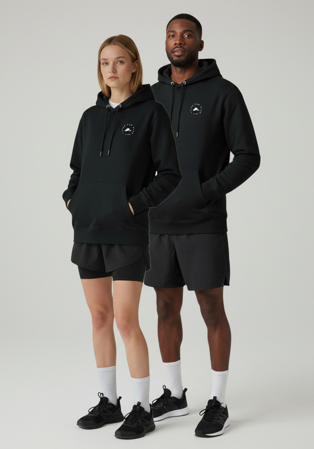 Layer Run Club black hoodie worn by male and female runners standing side by side
