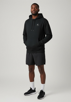 Layer Run Club black hoodie front view worn by male runner with hands in pocket