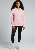 Female athlete wearing the pink Layer Run Club hoodie, front view styled with leggings for everyday training and recovery.