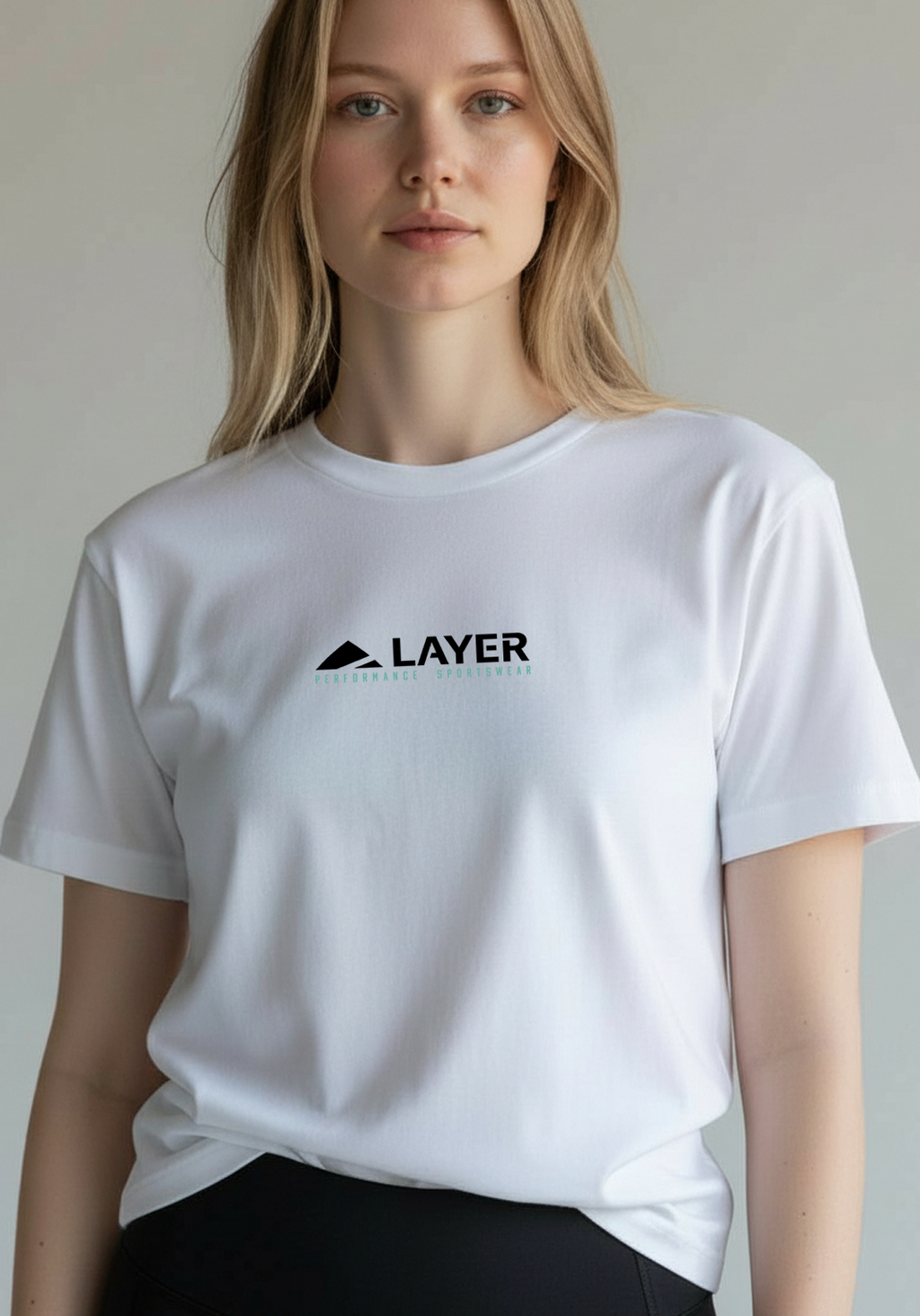 Woman wearing a white regular-fit Layer PS Signature Tee, shown from the waist up, standing against a neutral background.