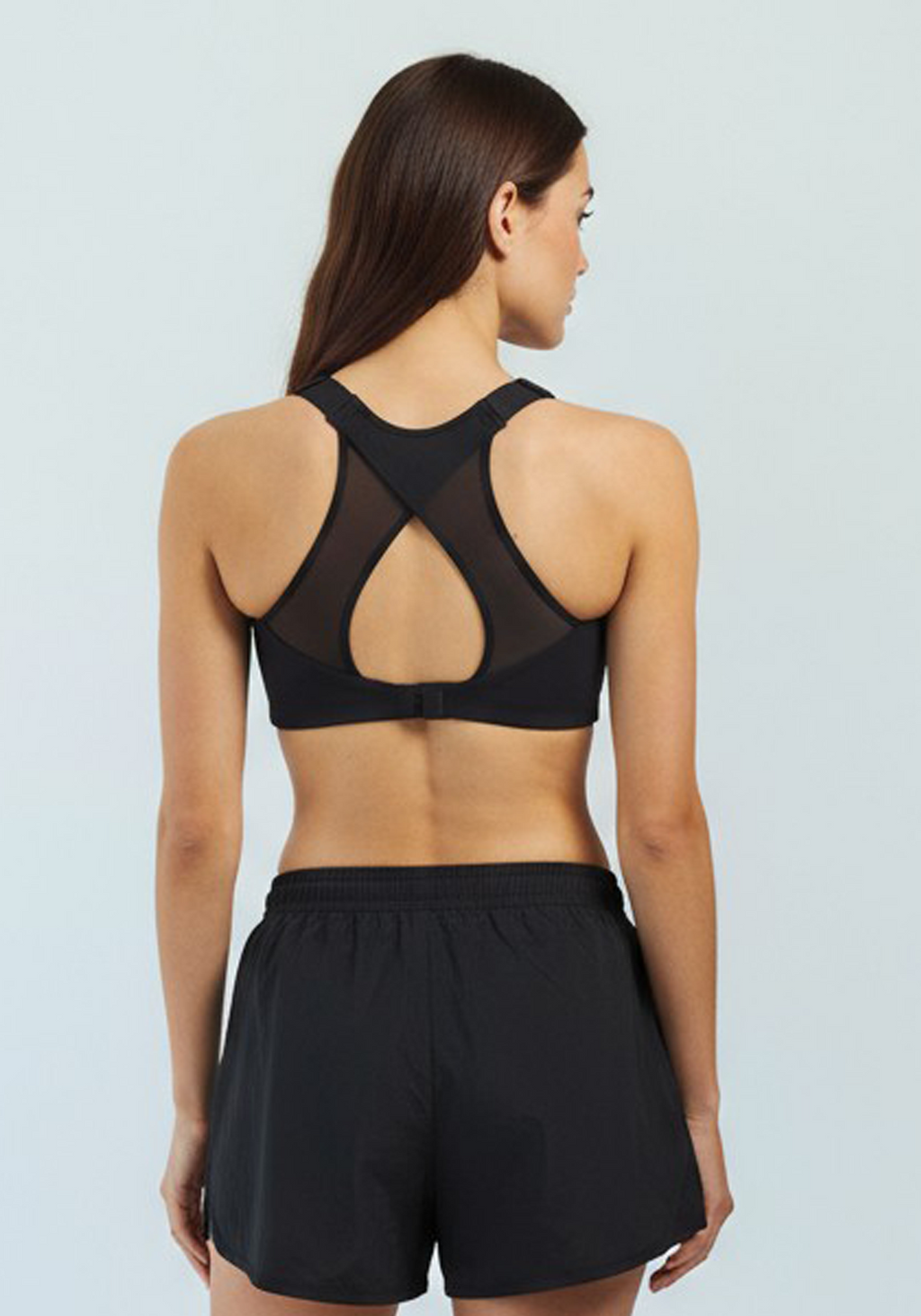 Layer Women’s Performance Bra in black – on-model back view showing mesh panel and crossover strap design for ventilation and support