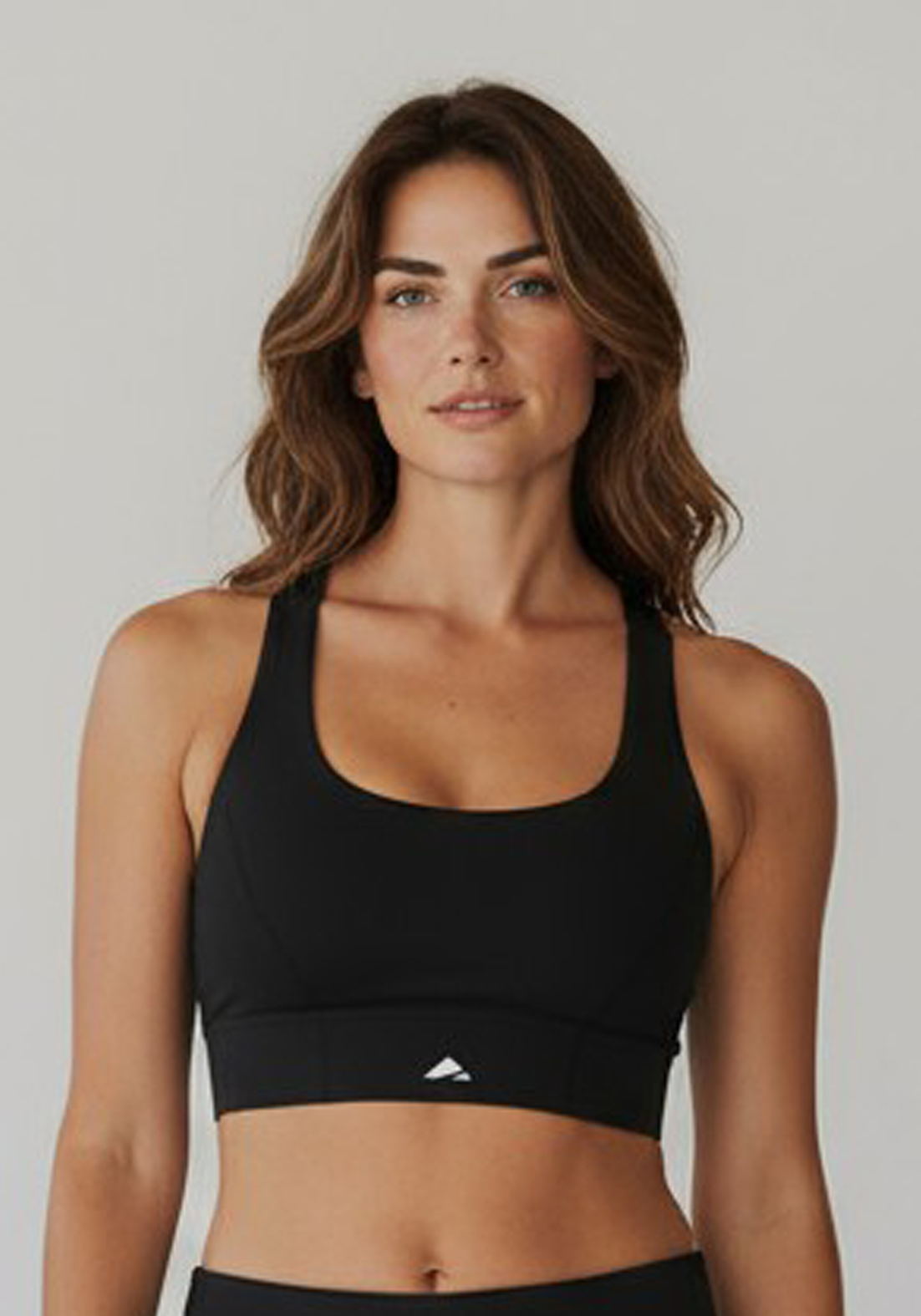Layer Women’s Performance Bra in black – close-up front view showing scoop neckline and smooth technical finish