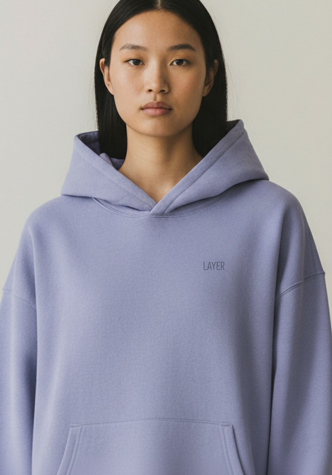 Close up of the Womens Layer Reset Hoodie in Lavender showing hood structure and minimal Layer logo.