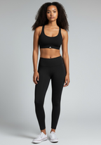 Layer Training Bra black worn with black leggings, full body front view