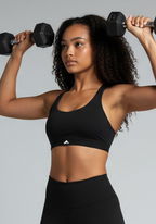 Layer Training Bra black during strength training, showing secure medium support