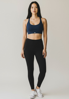 Layer Training Bra navy worn with black leggings, full body front view