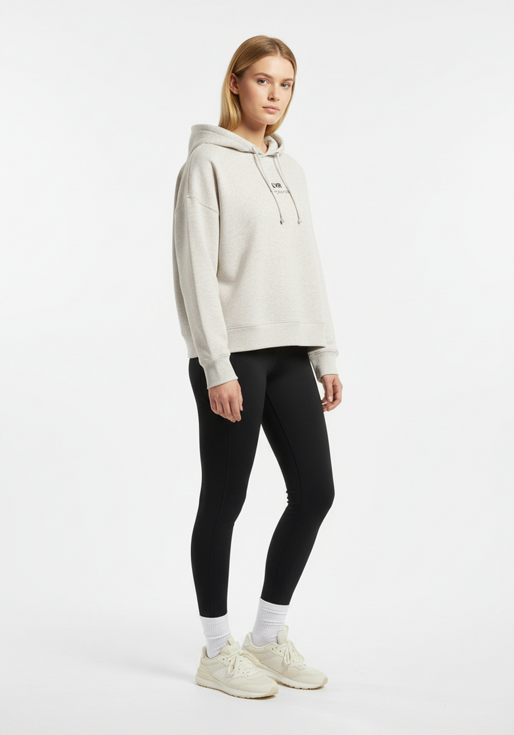 Side view of woman wearing Layer Love Your Run hoodie in warm grey, casual performance style