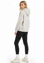 Front three quarter view of Layer Love Your Run hoodie in warm grey on female model