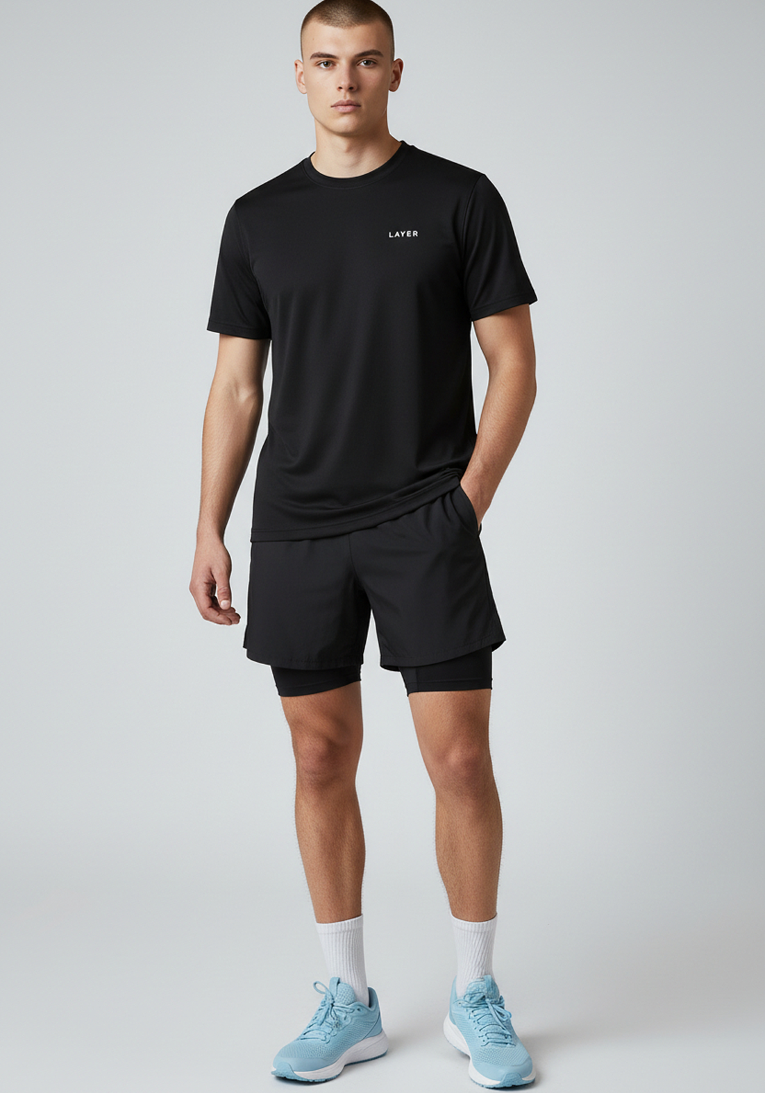 Angled front view of men’s black Layer FTR graphic running tee showing fit and drape