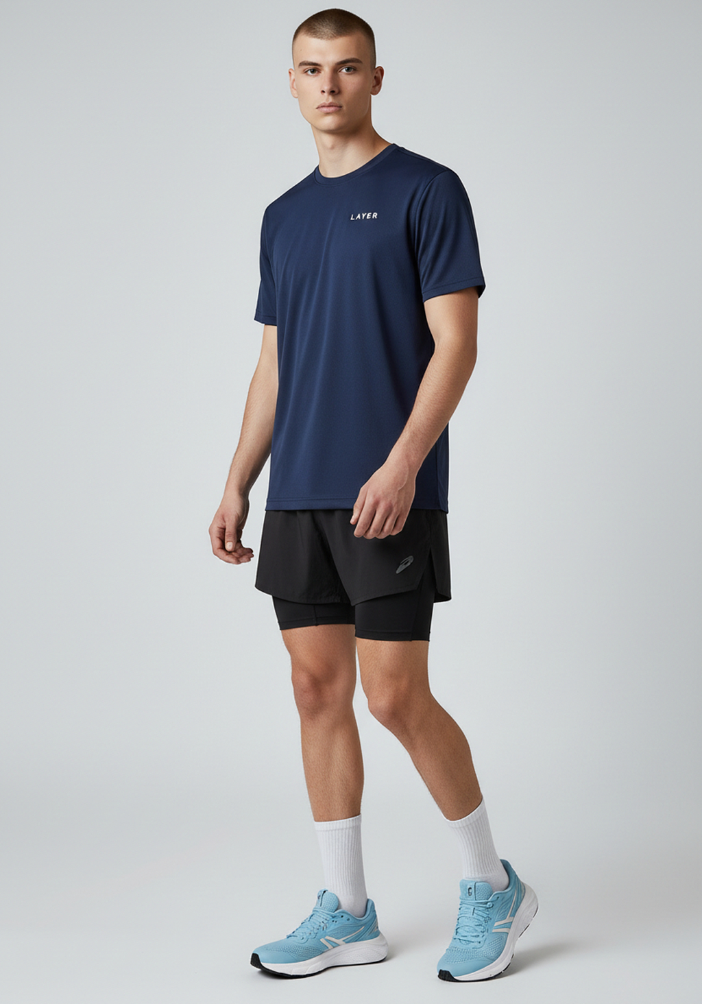 Angled front view of men’s navy Layer FTR graphic running tee showing fit and drape