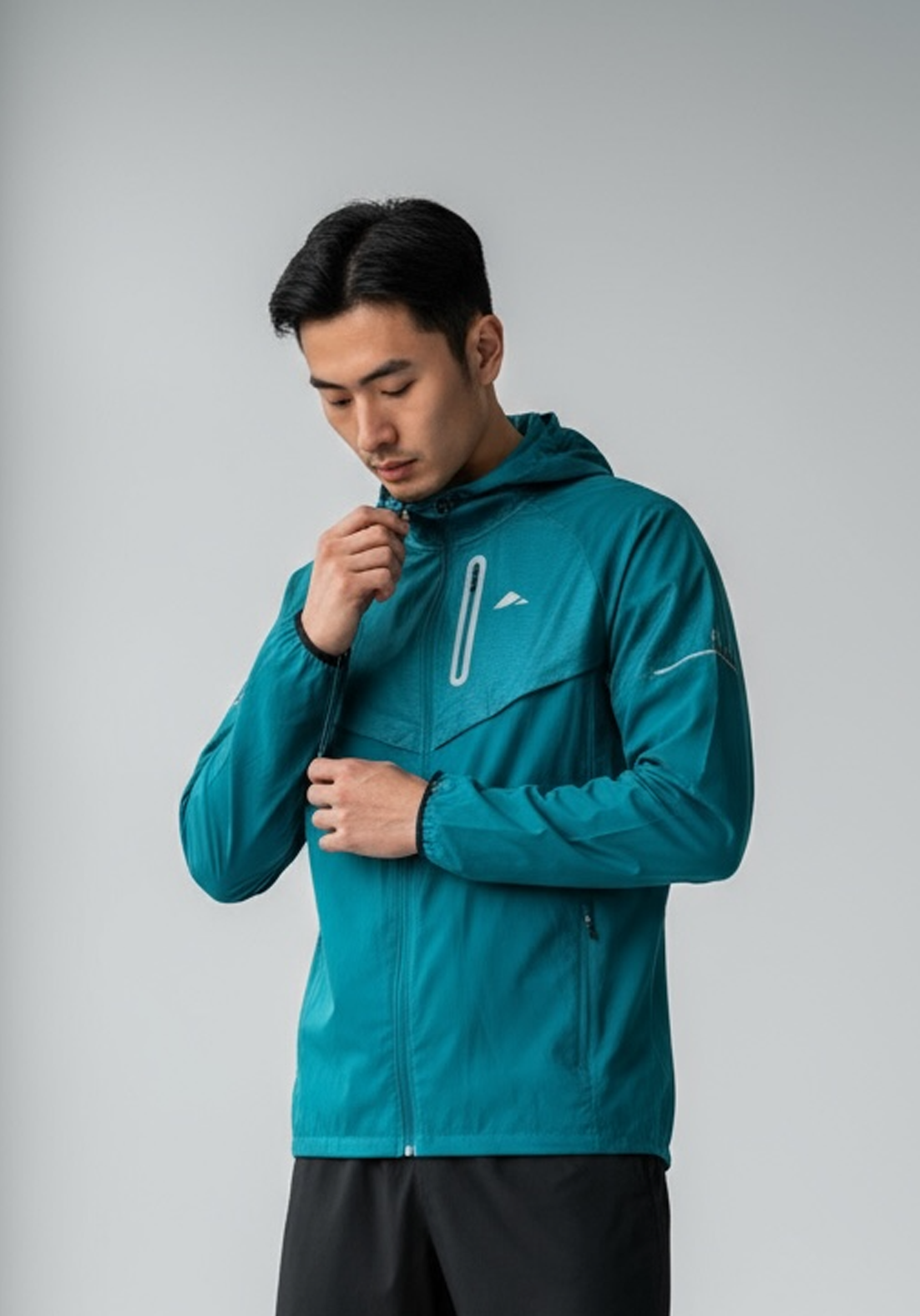Layer Tempo Running Windbreaker in alpine green, side view with reflective trim
