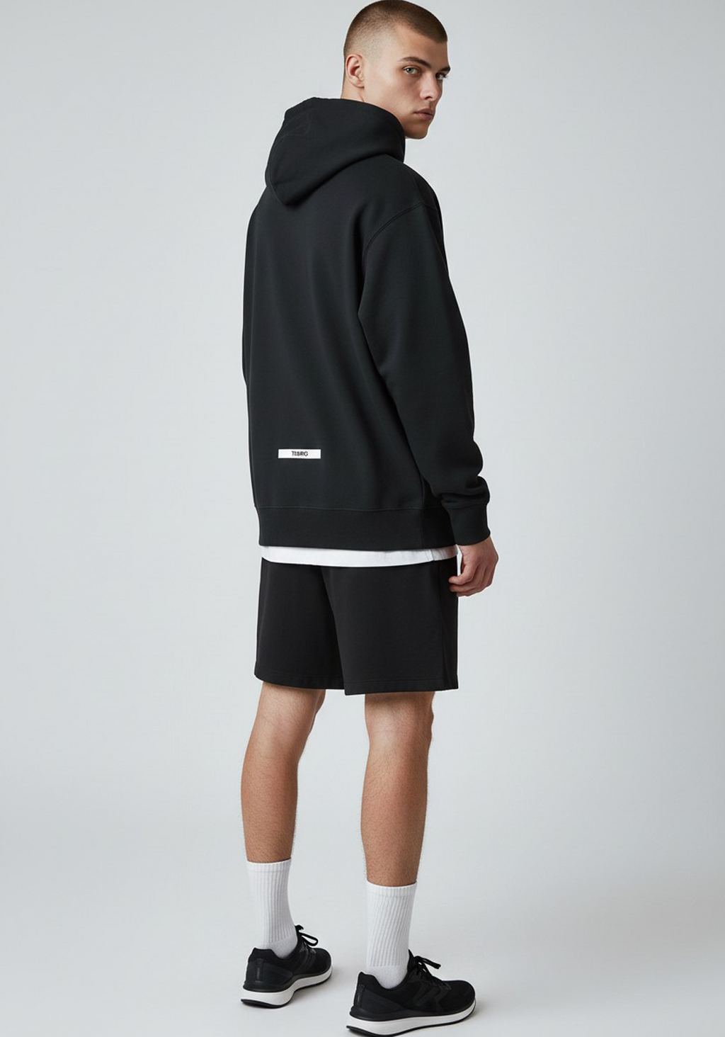 Layer Tempo Training Hoodie black rear three quarter view worn by male athlete