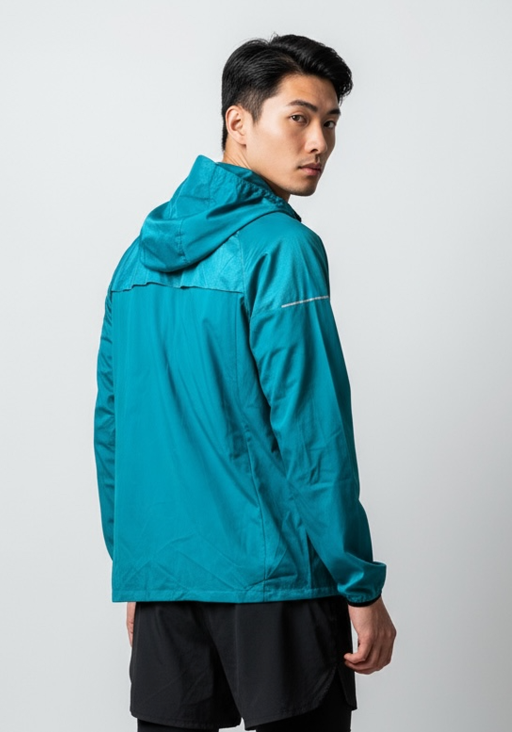 Layer Men’s Tempo Windbreaker in alpine green – on-model back view showing relaxed athletic fit and ventilation details