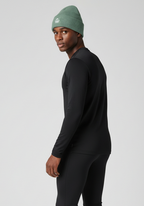 Model wearing alpine green Layer Track Club beanie, side profile