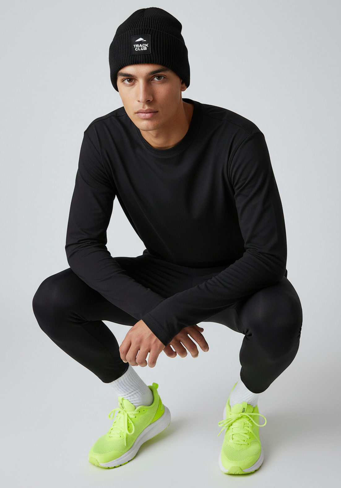 Close up of black Layer Track Club beanie with Track Club patch detail