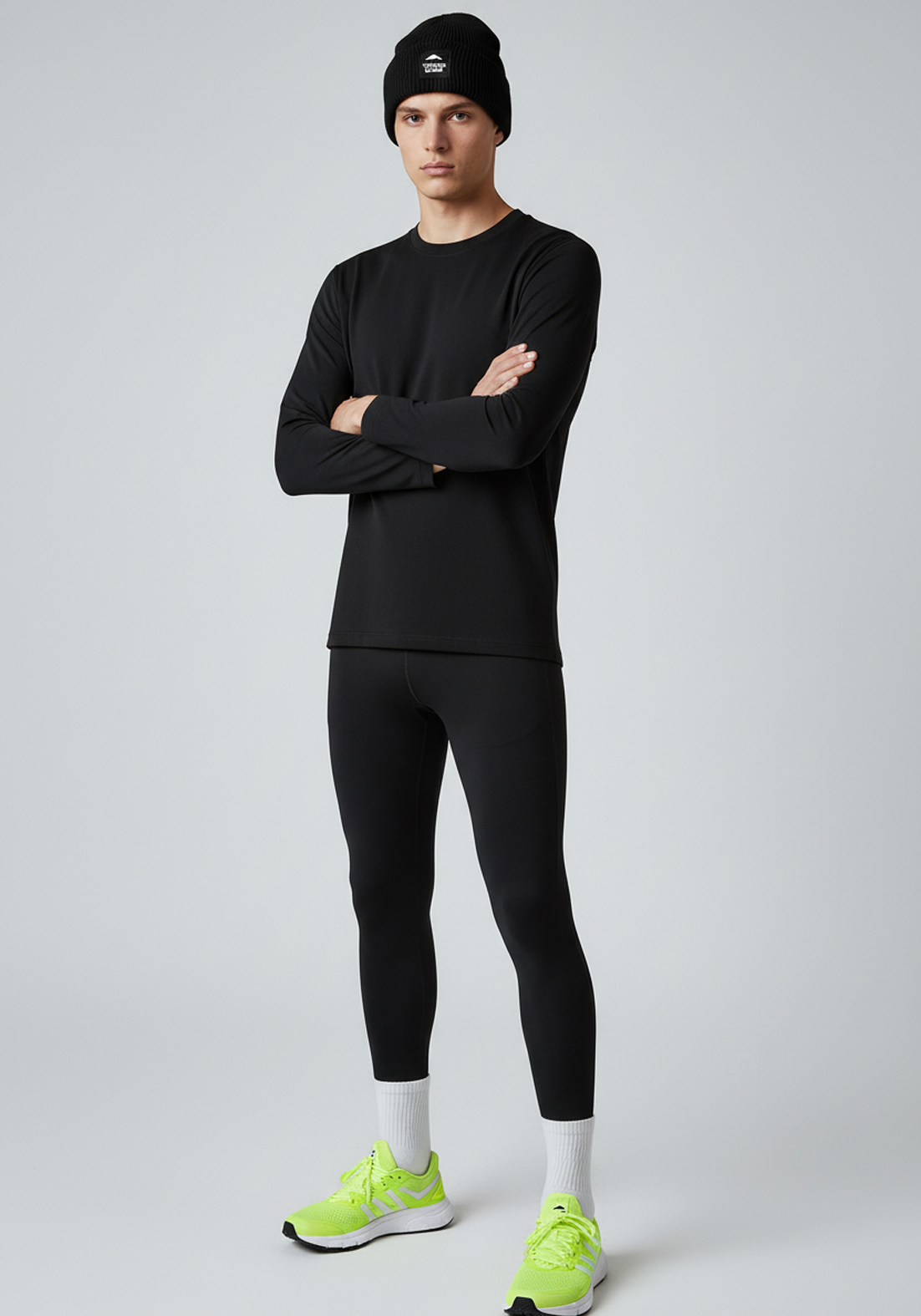 Front view of black Layer Track Club beanie worn with Layer performance base layer