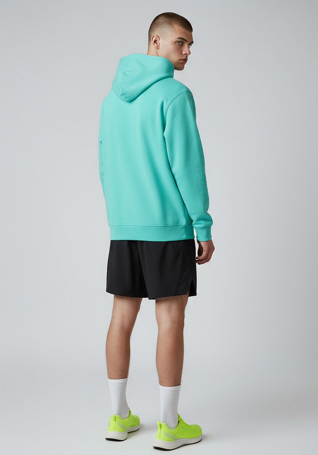 Layer Men’s Track Club Hoodie in teal – on-model back view highlighting modern silhouette and hood detail
