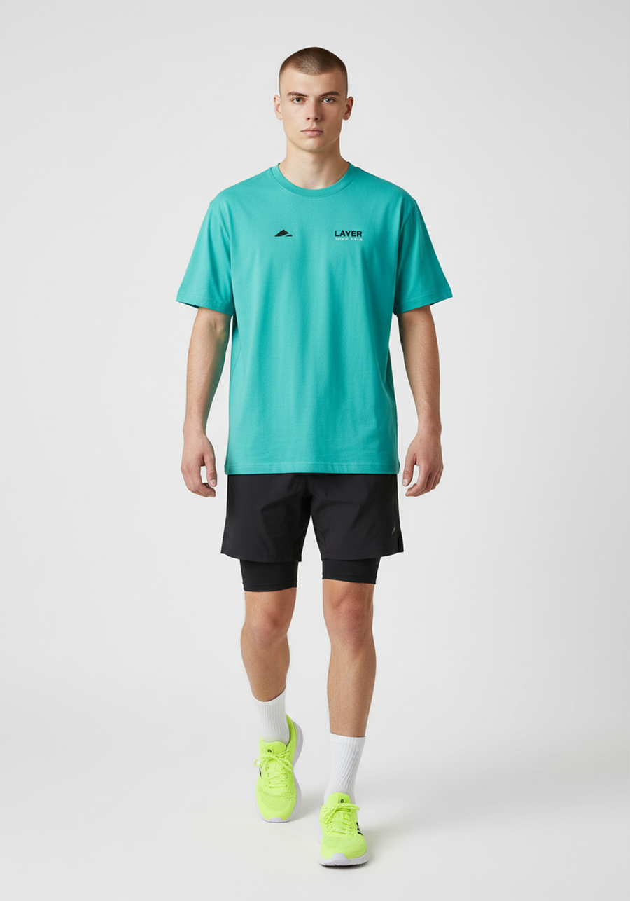 Layer Track Club Tee in teal, full-length view on-model
