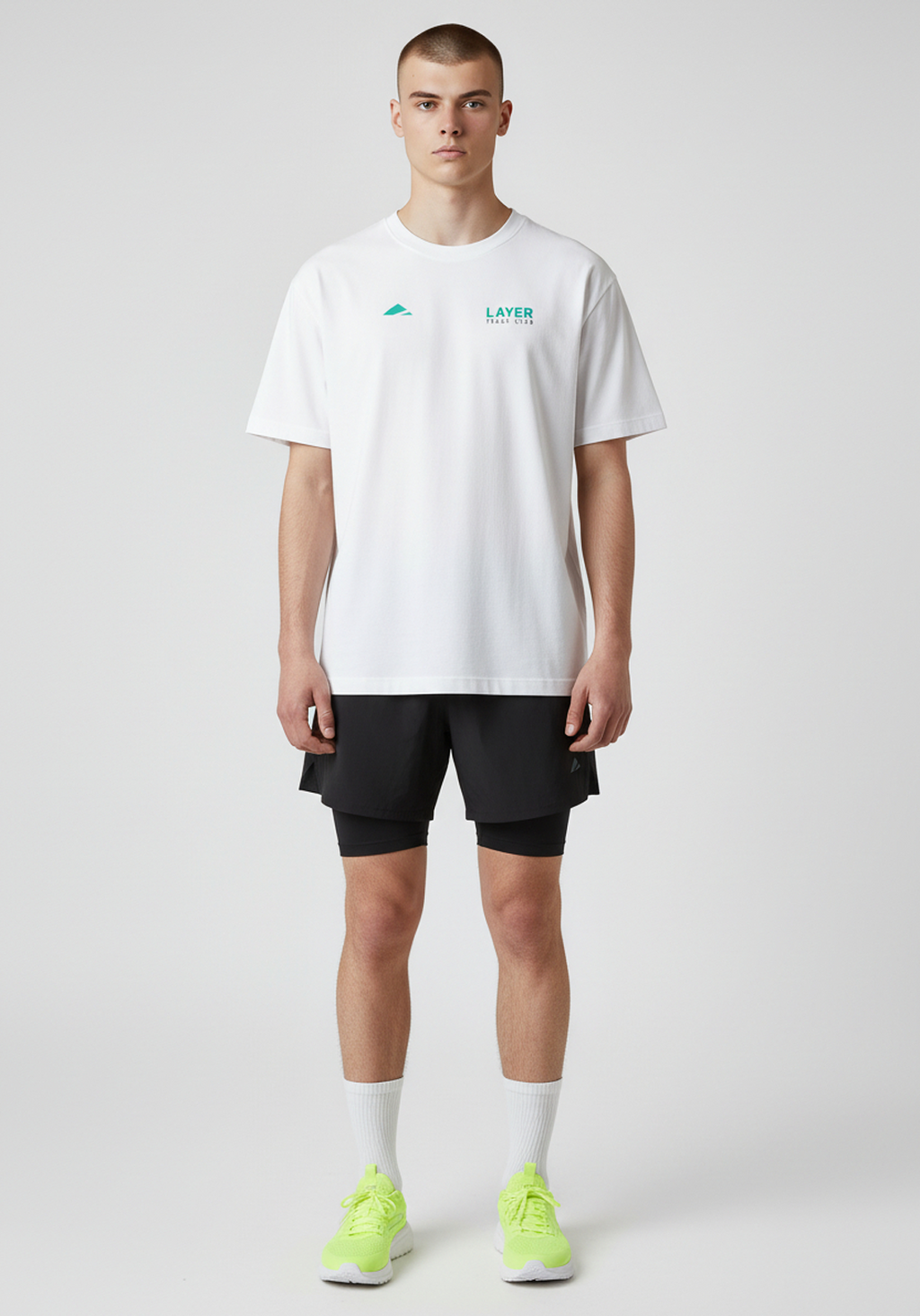 Model wearing white Layer Track Club tee front view with chest logo