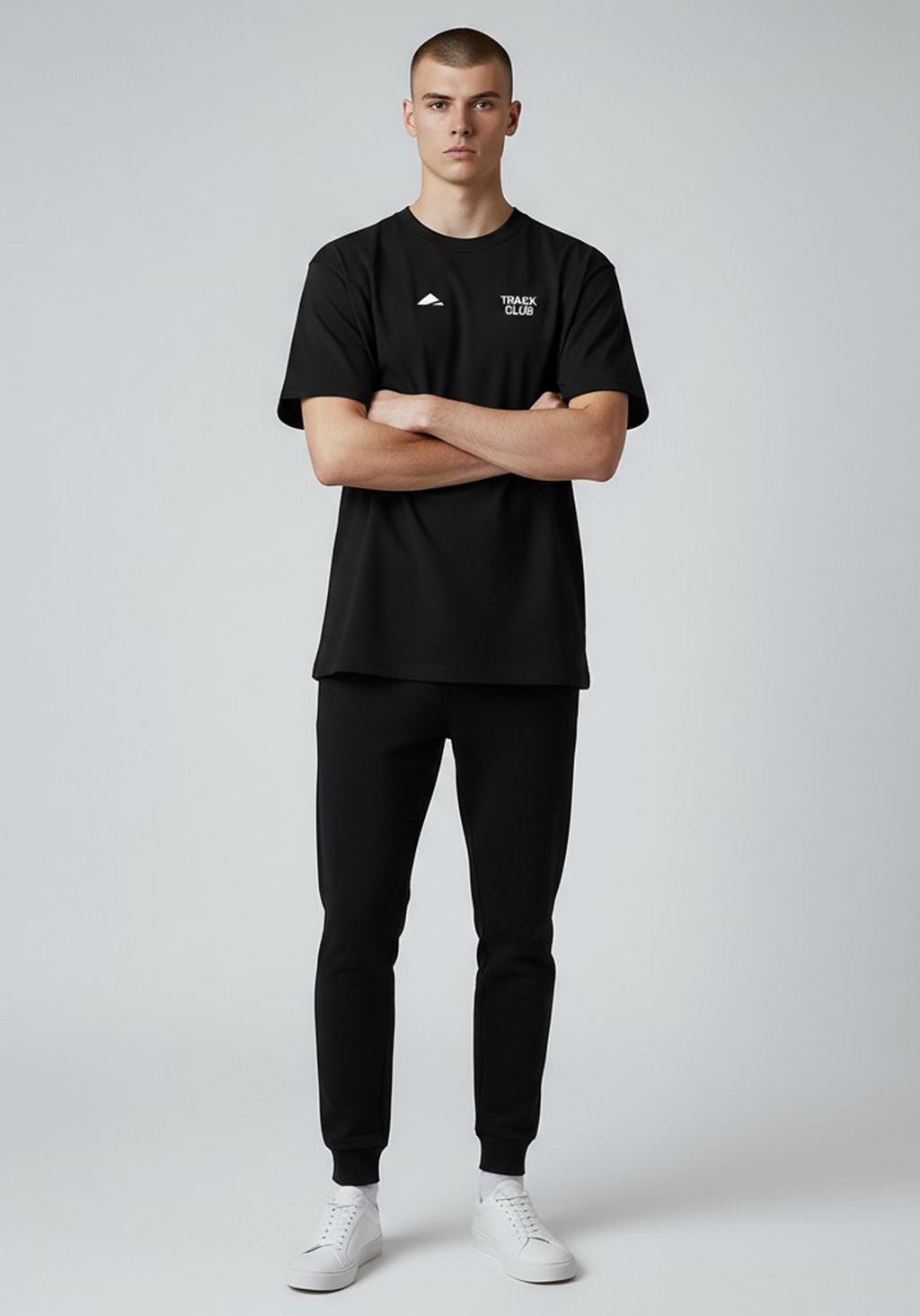 Layer Track Club Tee in black – full-body front view on model showing minimalist chest print and athletic fit