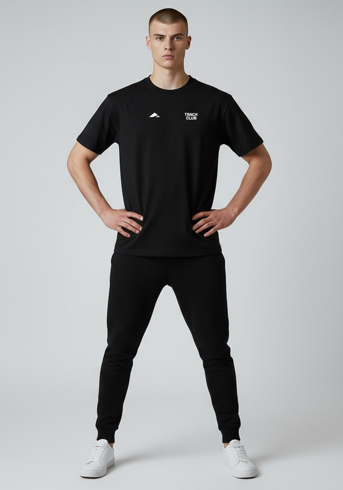 Layer Track Club Tee in black – full-body front stance on model paired with joggers and white sneakers