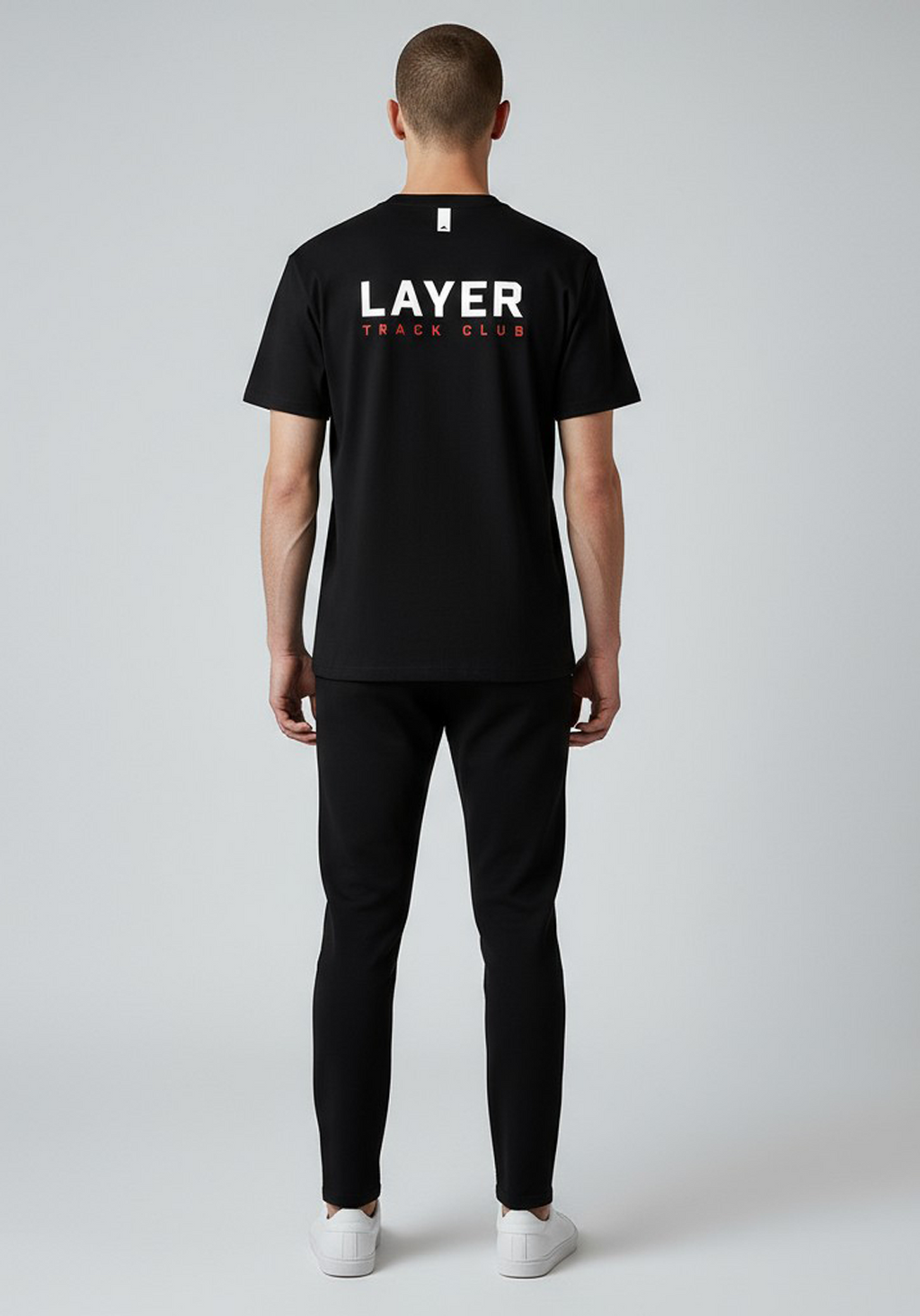 Layer Track Club Tee in black – back view on model showcasing large Layer logo and relaxed silhouette