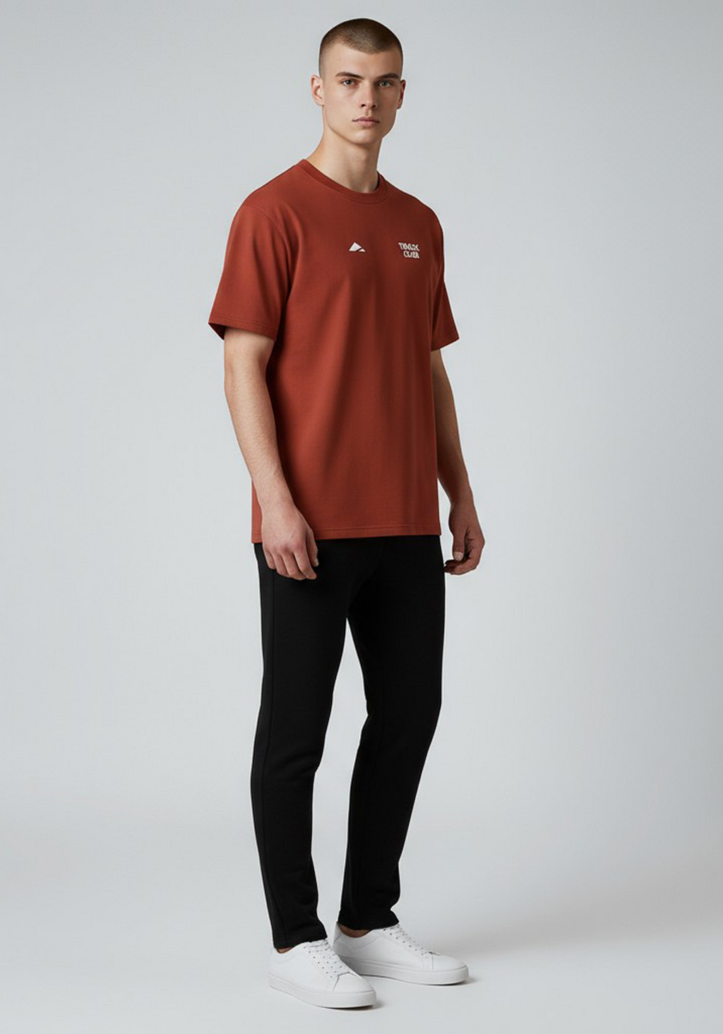 Layer Track Club Tee in Deep Red – angled front view on model paired with black joggers and white sneakers