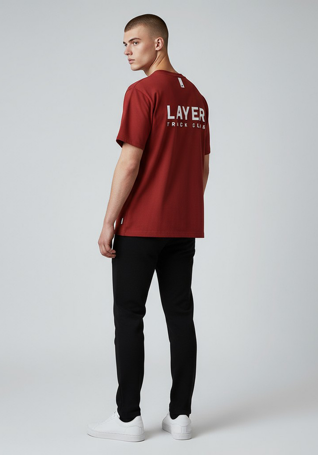 Layer Track Club Tee in Deep Red – angled back view on model highlighting bold LAYER TRACK CLUB back print