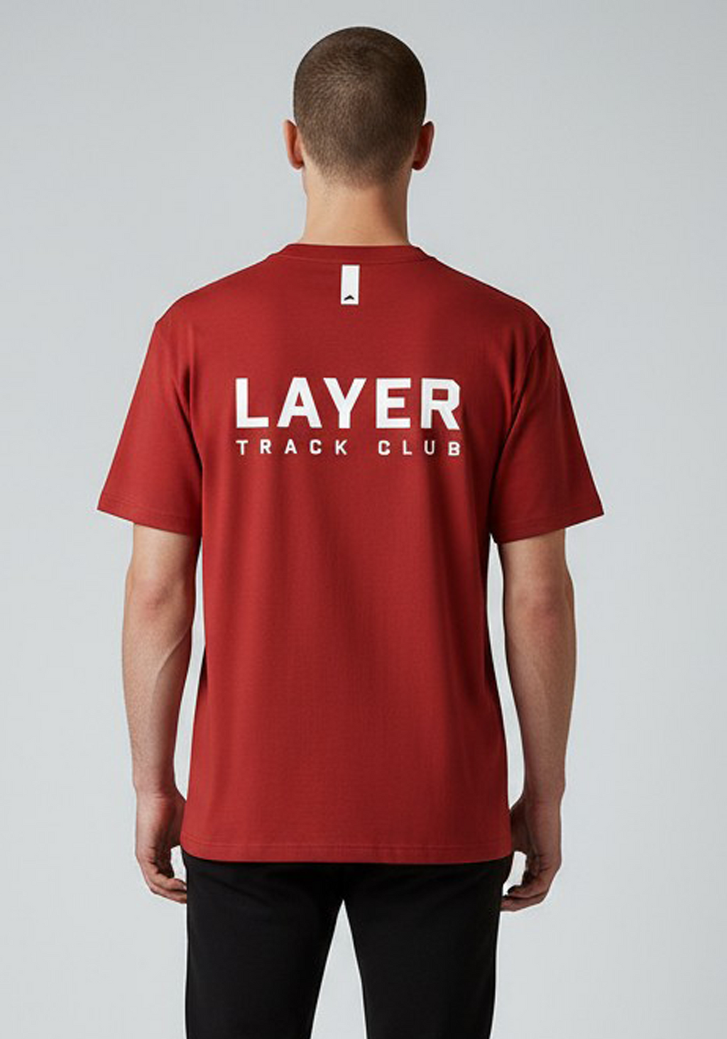 Layer Track Club Tee in Deep Red – back view on model showing large white logo print and minimal detail tab
