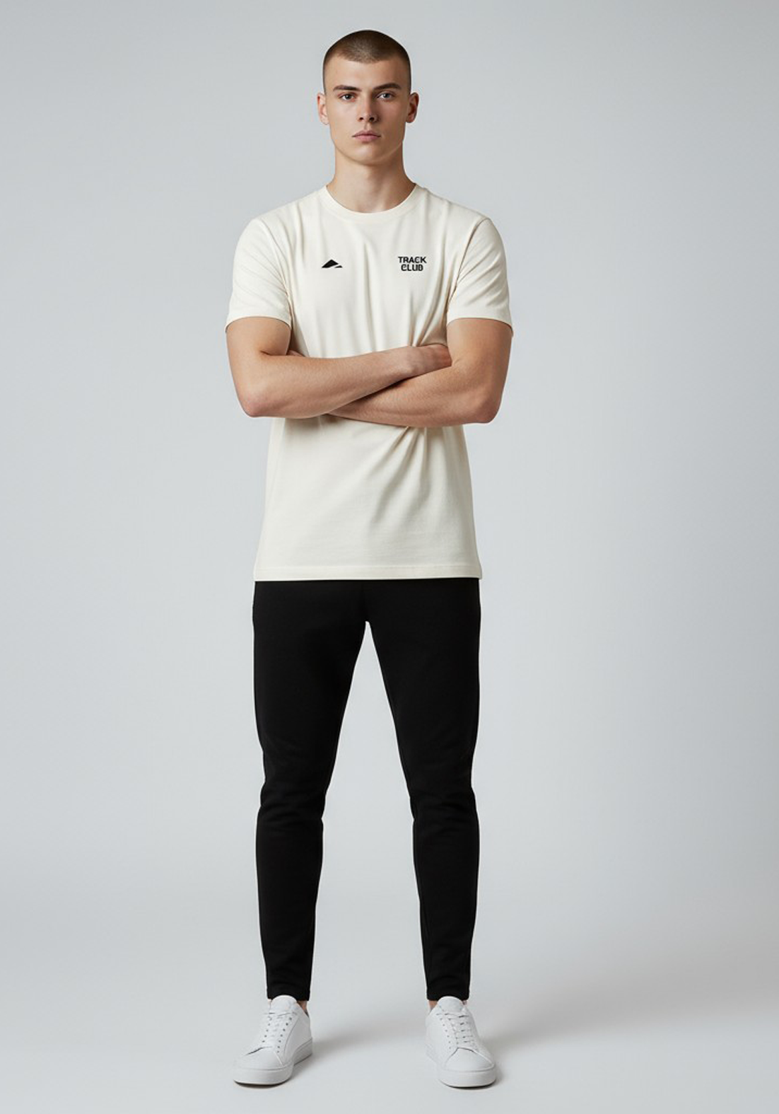 Layer Track Club Tee in Dune White – full-body front view on model paired with black joggers and white sneakers