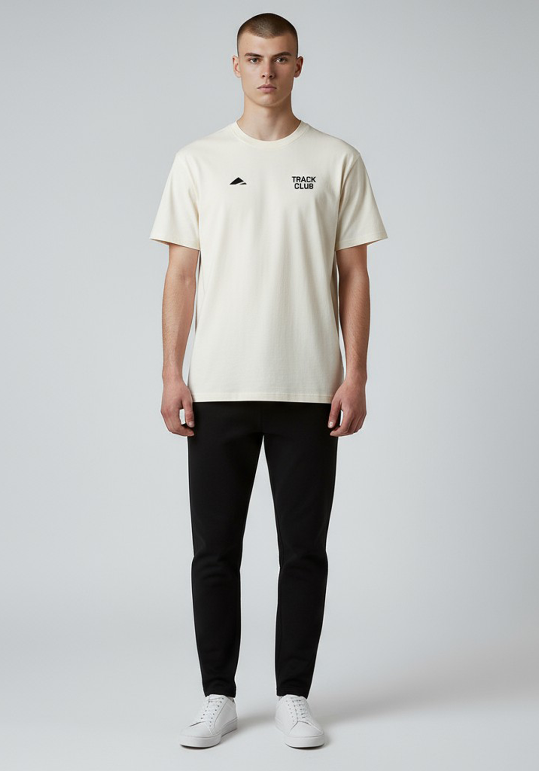 Layer Track Club Tee in Dune White – front view on model showing relaxed athletic fit and minimalist design