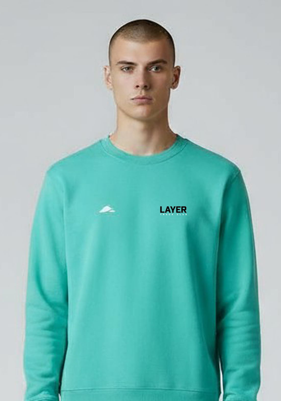 Layer Men’s Track Club Sweatshirt in teal – close-up front detail showing logo and textured finish