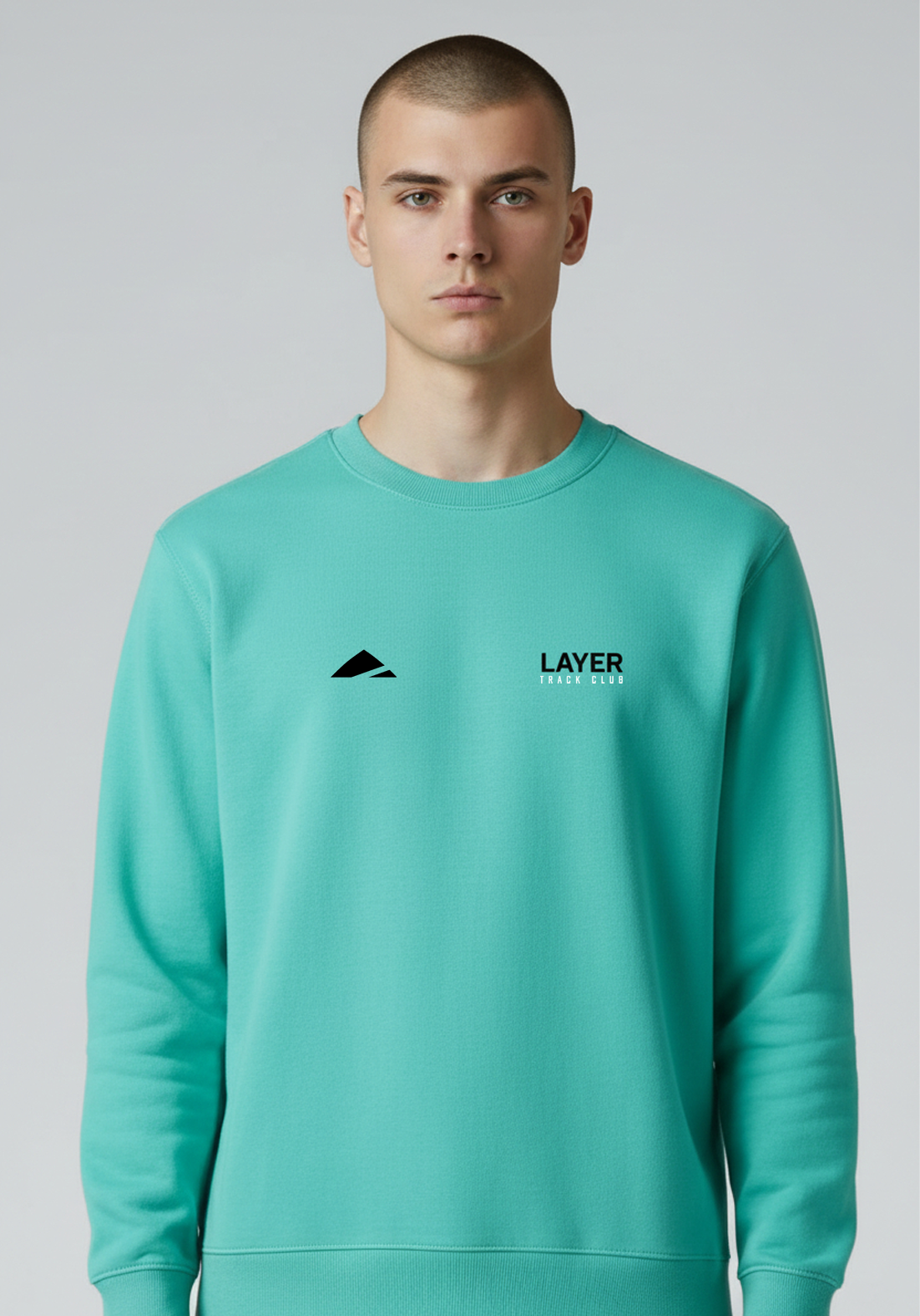 Layer Track Club sweatshirt in teal worn by male model front view with Layer branding on chest