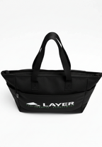 Layer Trackside Tote front view showing structured black training tote with Layer Performance branding