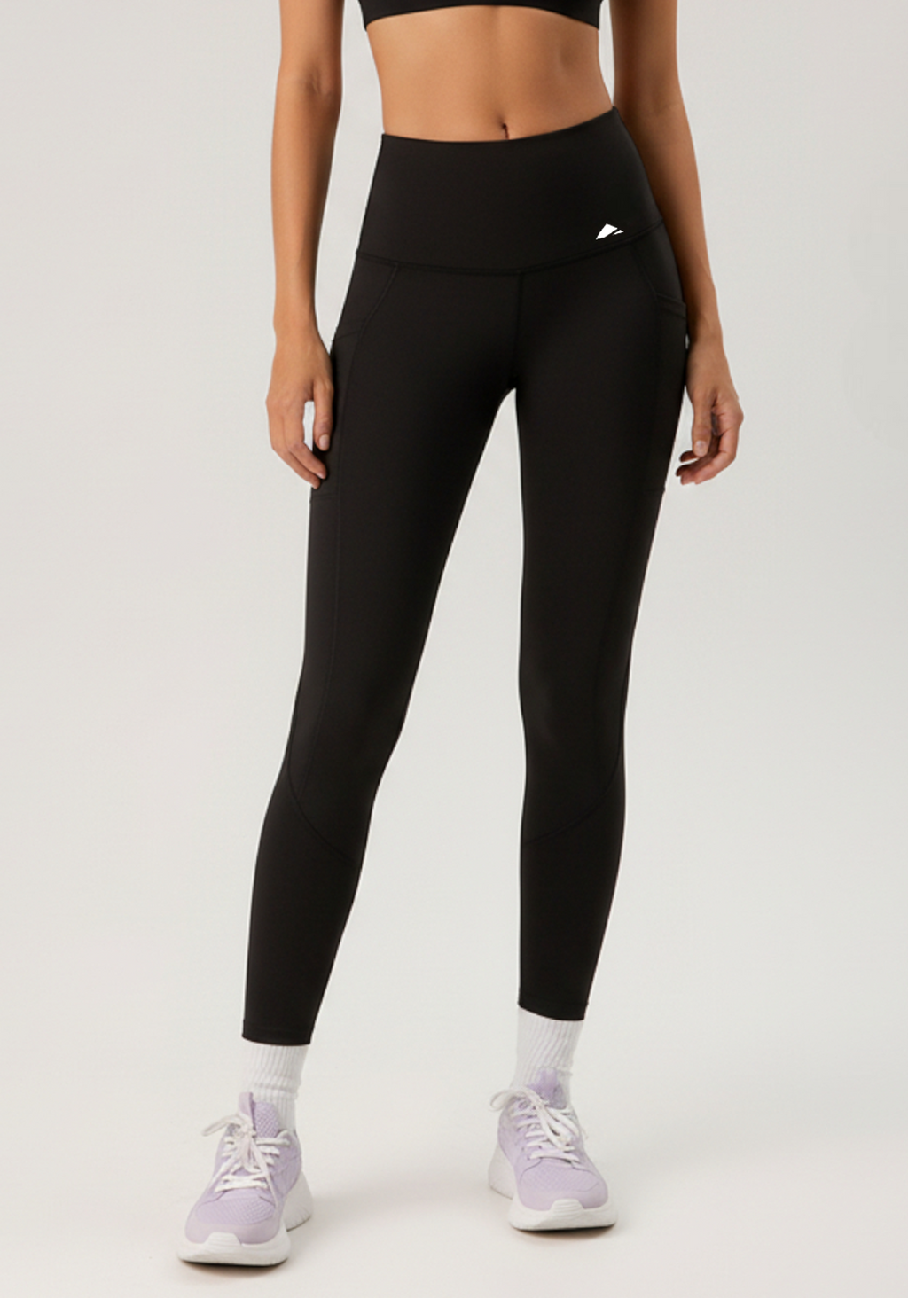Front view of model wearing black Vento Hybrid Performance Leggings with high-waisted compression fit, shown full length.