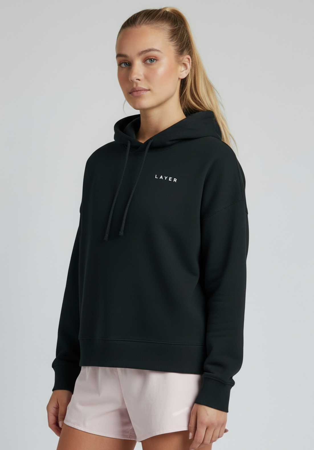 Close-up of women’s black Layer FTR Graphic Hoodie showing hood and chest branding