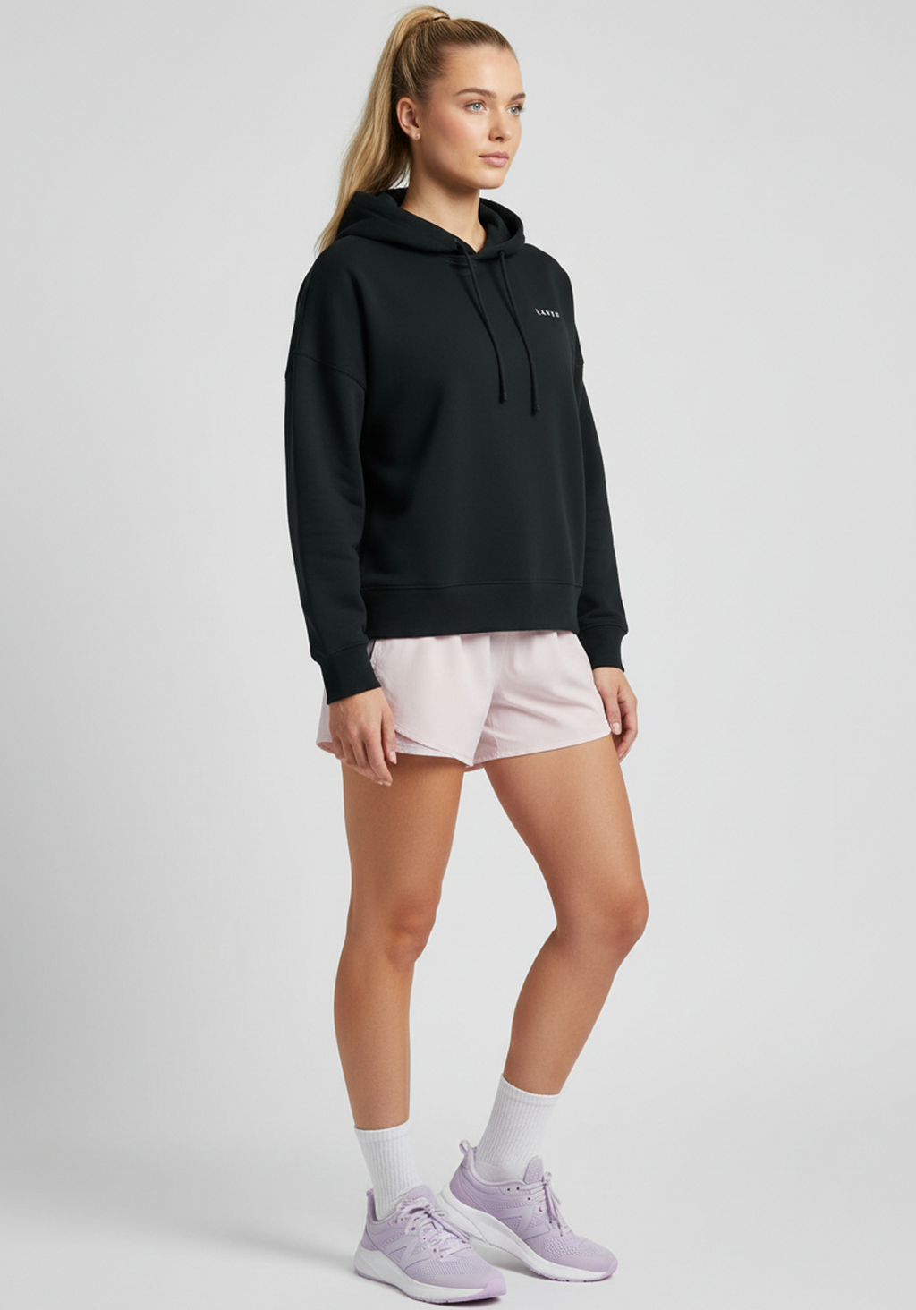 Front view of women’s black Layer FTR Graphic Hoodie with subtle Layer chest logo