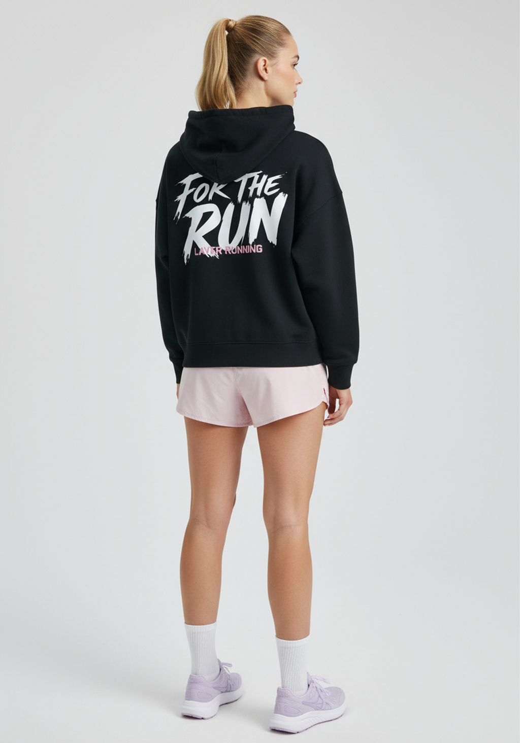 Angled back view of women wearing black Layer FTR Graphic Hoodie with rear graphic