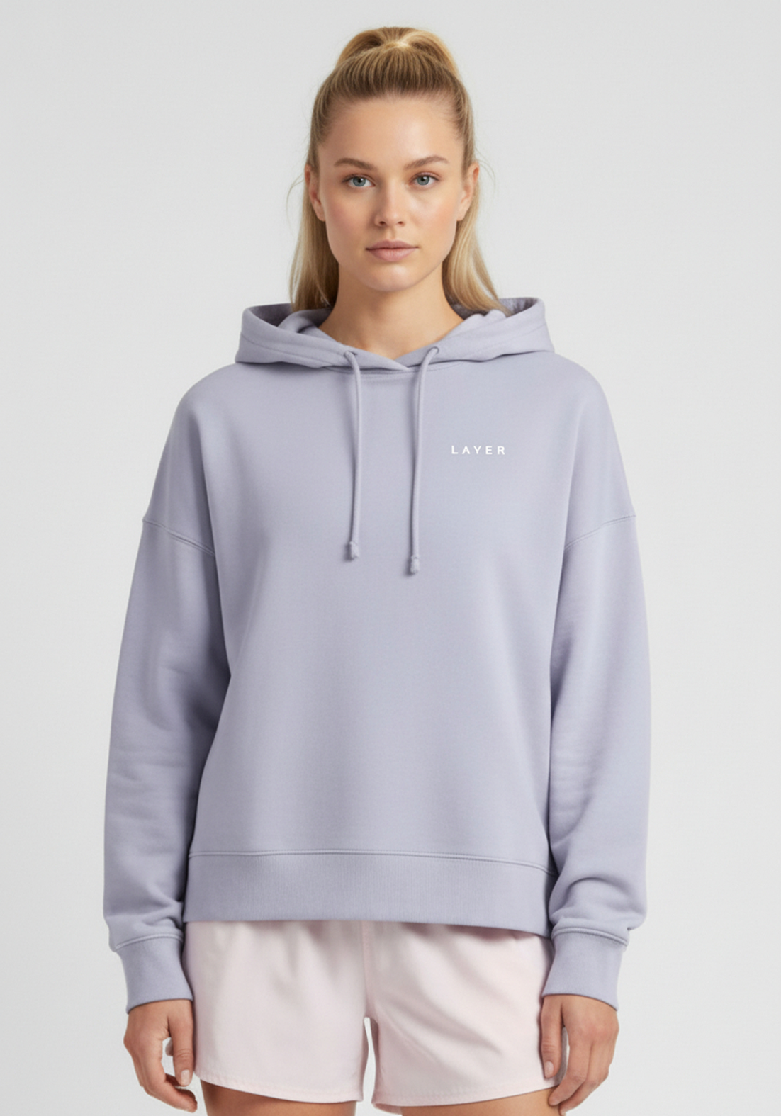 Close up front view of women’s lavender Layer FTR Graphic Hoodie with subtle chest logo