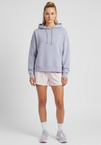 Women wearing lavender Layer FTR Graphic Hoodie styled with running shorts, angled front view