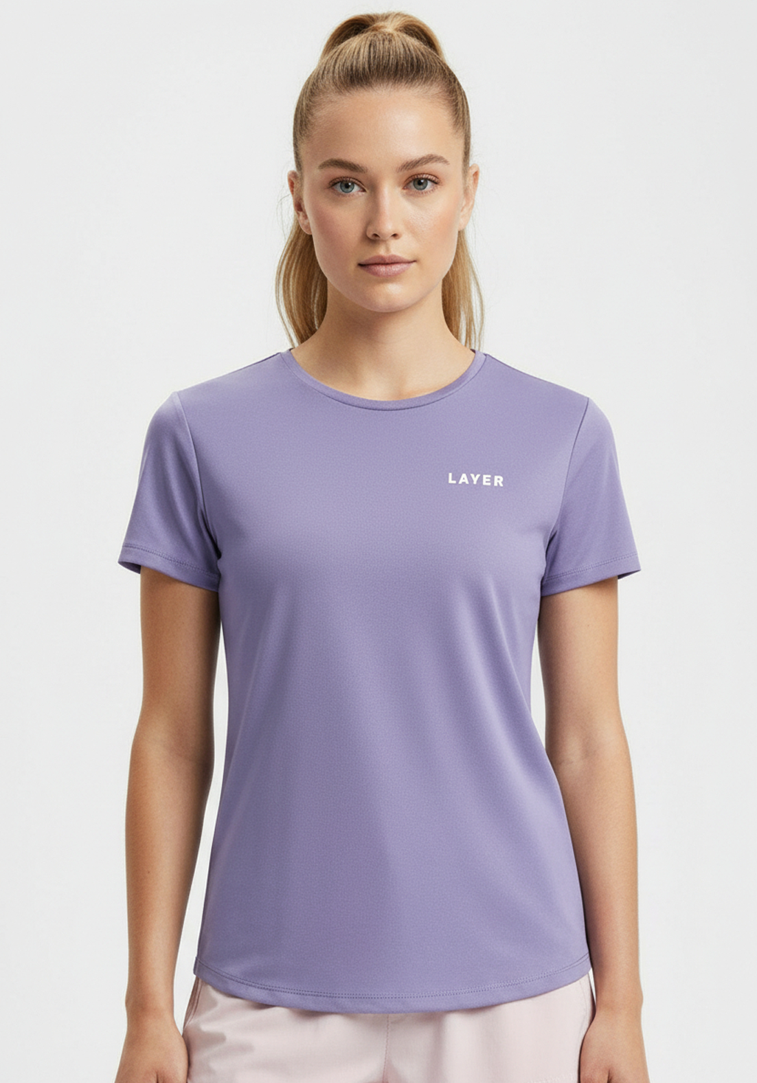 Close-up of women’s lavender Layer FTR Graphic Run Tee showing crew neck and subtle Layer chest logo