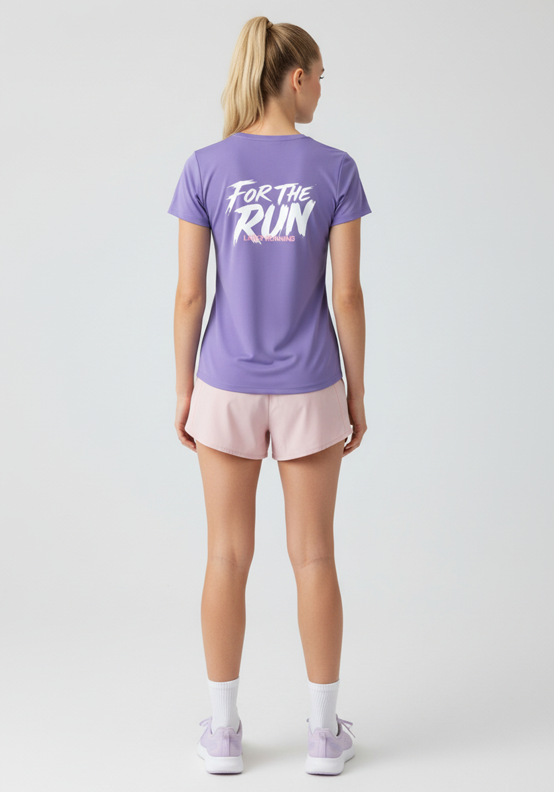 Angled rear view of lavender Layer FTR Graphic Run Tee showing relaxed fit and For The Run back graphic